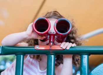 Close-up of girl looking through binoculars