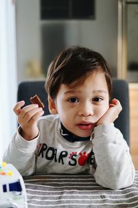 Portrait of cute boy playing at home