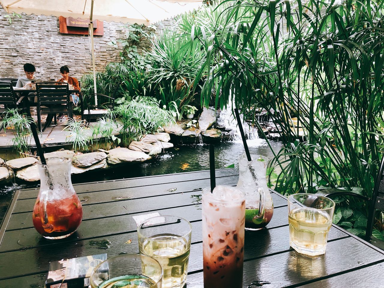 POTTED PLANTS ON GLASS TABLE AT RESTAURANT