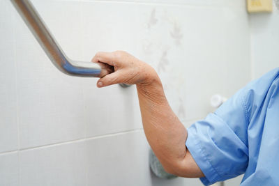 Close-up of human hand on wall