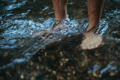 Low section of man sanding in river