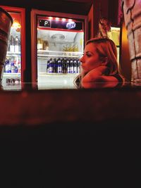 Woman in illuminated restaurant at night