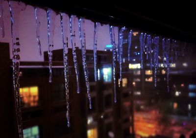 Reflection of illuminated lights in puddle