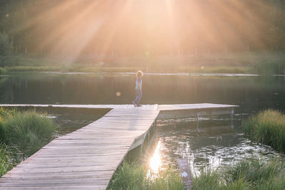 Rear view of man fishing in lake