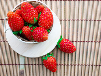 High angle view of strawberries in bowl on table