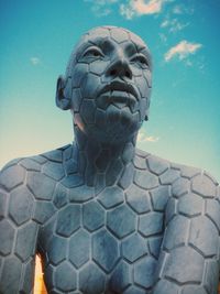 Low angle view of statue against blue sky