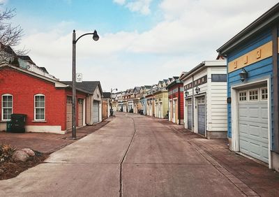 Empty road with buildings in background