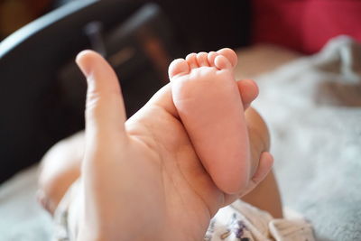Close-up of hand holding baby foot 