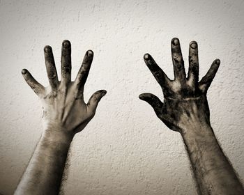 Close-up of hand touching wall