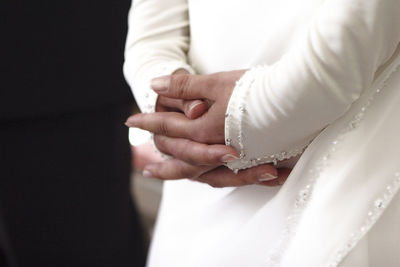 Midsection of couple holding hands