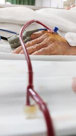 Close-up of patient receiving blood transfusion in a hospital ward