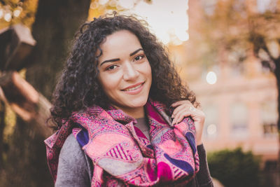 Portrait of smiling young woman standing outdoors