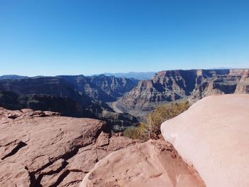 Scenic view of mountains against clear blue sky