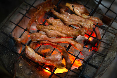 Pork grilled over a charcoal fire.