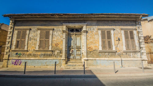 Low angle view of old building against blue sky