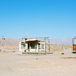 Built structure on desert against clear blue sky