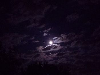 Low angle view of silhouette moon against sky at night