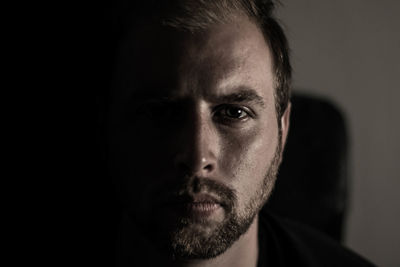 Close-up portrait of young man against gray background