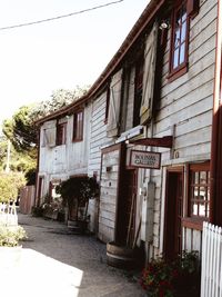 Exterior of house by building against sky