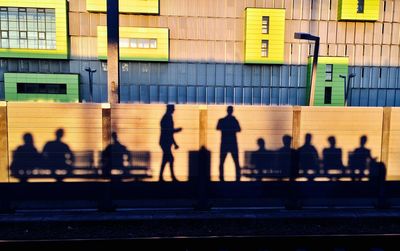 Shadow of people at railroad station platform