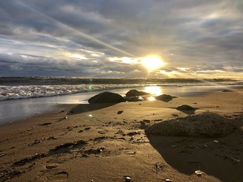 Scenic view of beach against sky during sunset