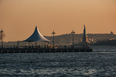 View of boats in sea at sunset