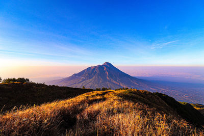 View of volcanic mountain against blue sky