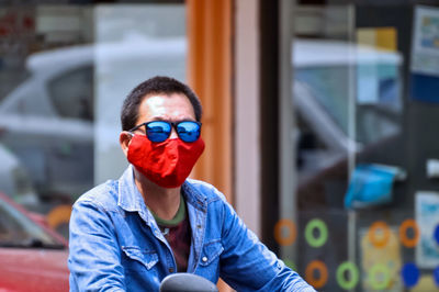 Man wearing mask and sunglasses