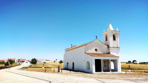 Church against clear blue sky during sunny day