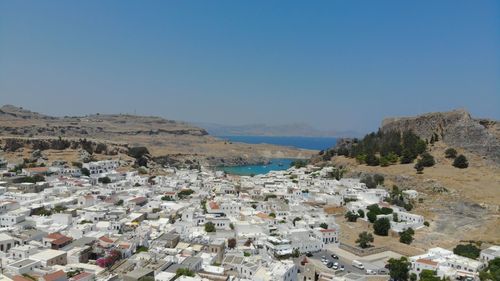Buildings in town against clear blue sky