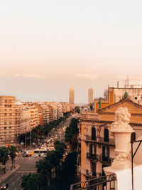 Buildings in city at sunset