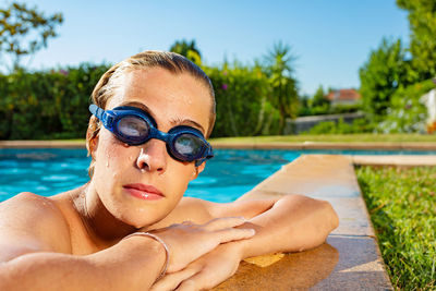 Portrait of young man swimming in pool