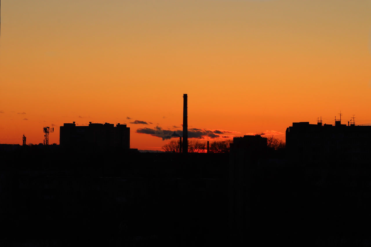 SILHOUETTE BUILDINGS AGAINST ORANGE SKY