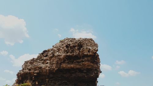 Low angle view of rock formation against sky