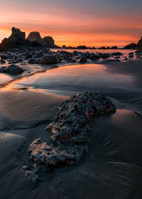 Scenic view of beach against sky during sunset