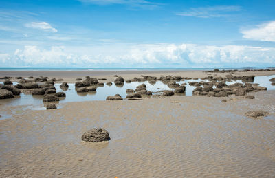 Panoramic view of rocks on beach against sky