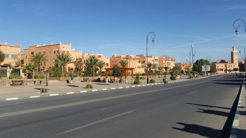 View of city street against blue sky