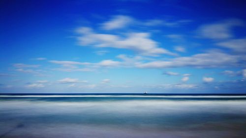 Scenic view of sea against blue sky