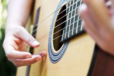 Cropped image of man playing guitar