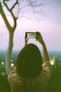 Rear view of person photographing