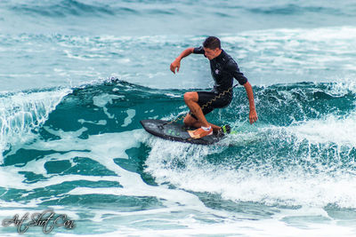 Full length of man surfing in sea