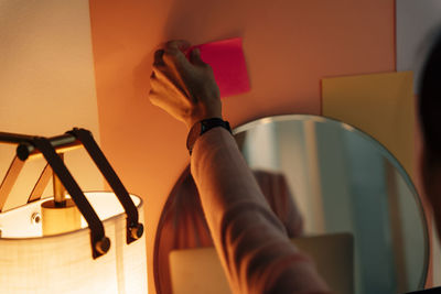 Cropped hand of woman holding adhesive tape in office