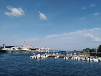 Scenic view of sea by buildings against sky