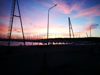 Sailboats moored at harbor