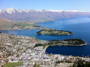 Aerial view of lake and mountains against clear sky