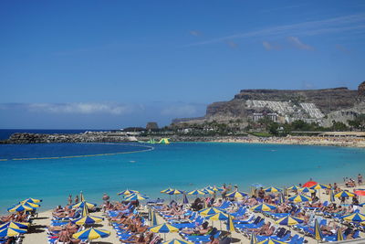 High angle view of people at beach against blue sky