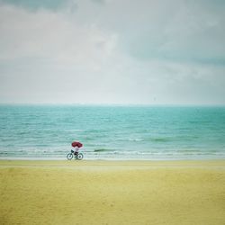 Man riding bicycle on beach