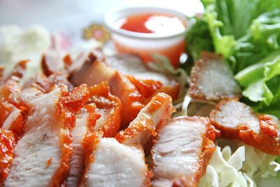 Grilled chicken and pork chop with salad, bread and mashed potato