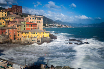 Scenic view of sea and buildings against sky