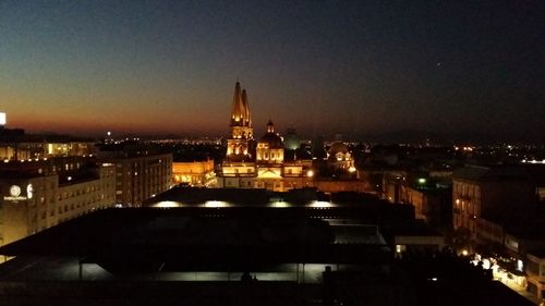 Illuminated buildings in city at night